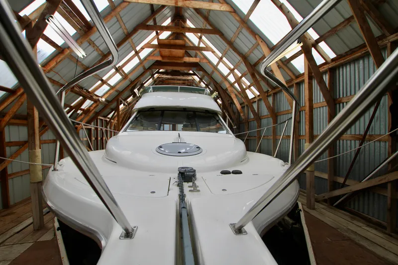 Slide: The Image of 1998 Bayliner 3788 Command Bridge Motoryacht in a wooden boathouse. - 3