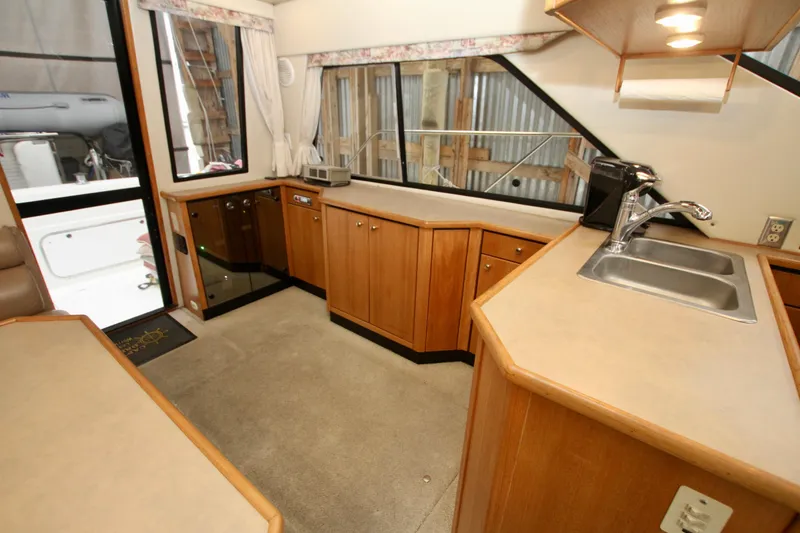 Slide: The Image of 1998 Bayliner 3788 Command Bridge Motoryacht interior with white seating and control panel. - 31