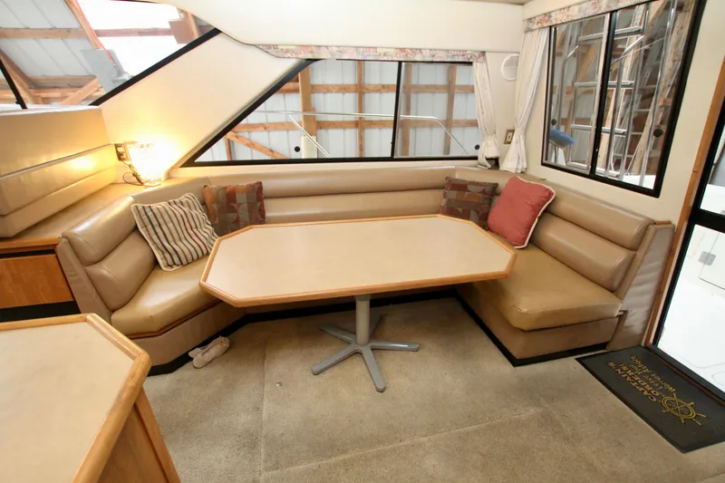 Slide: The Image of 1998 Bayliner 3788 Command Bridge Motoryacht interior with kitchen and dining area. - 33