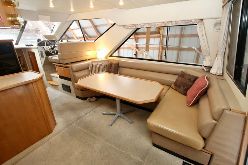 Slide: The Image of 1998 Bayliner 3788 Command Bridge Motoryacht interior with wooden cabinetry and control panel. - 34