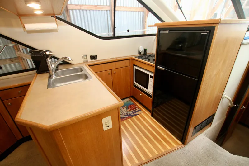 Slide: The Image of Interior of 1998 Bayliner 3788 Command Bridge Motoryacht with seating and table. - 37