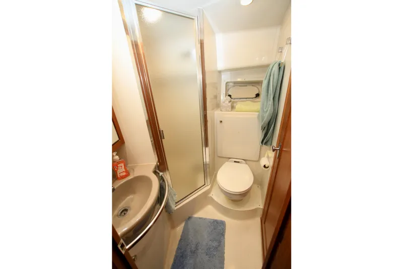 Slide: The Image of Bathroom of 1998 Bayliner 3788 Command Bridge Motoryacht with shower, sink, and toilet. - 56
