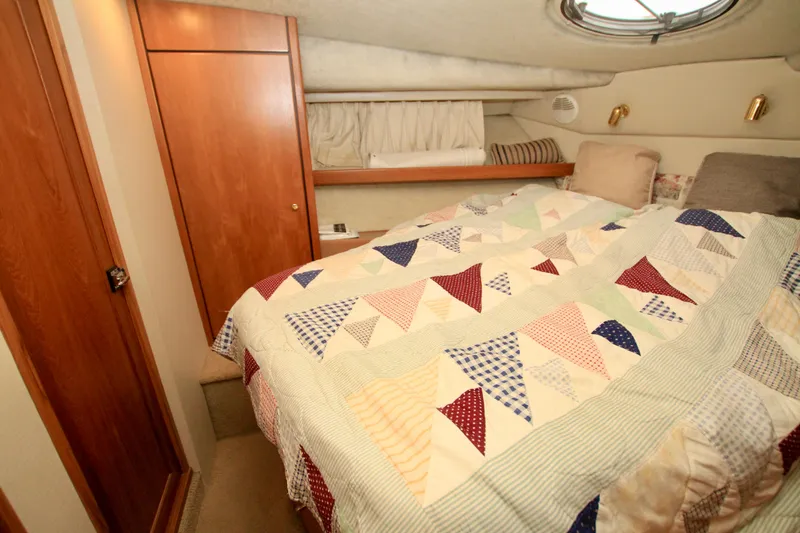 Slide: The Image of Cozy bedroom in 1998 Bayliner 3788 Command Bridge Motoryacht with quilted bedding. - 59