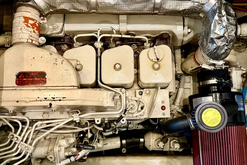 Slide: The Image of Engine compartment of a 1998 Bayliner 3788 Command Bridge Motoryacht, showcasing mechanical components. - 60