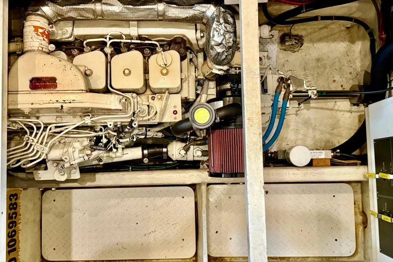 Slide: The Image of Engine compartment of 1998 Bayliner 3788 Command Bridge Motoryacht, showcasing mechanical components. - 61