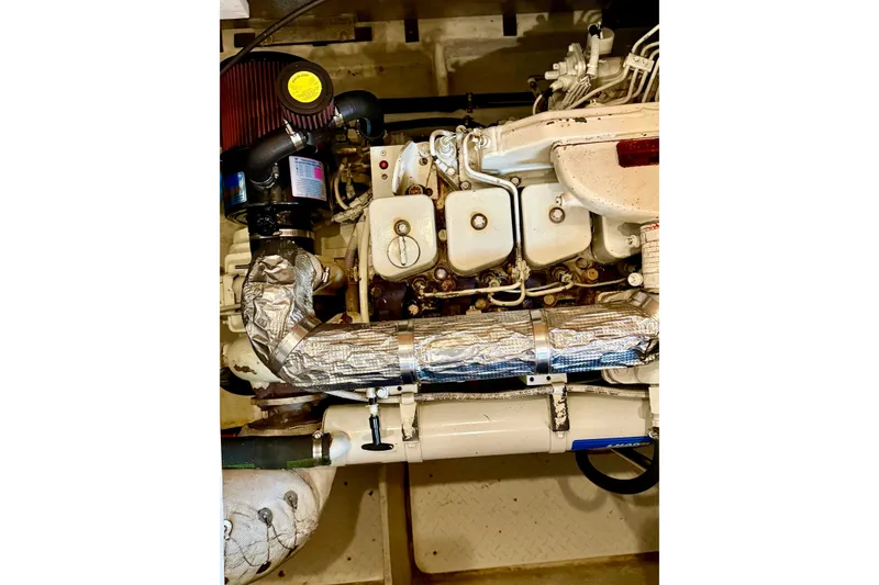 Slide: The Image of Engine of 1998 Bayliner 3788 Command Bridge Motoryacht, showcasing mechanical components. - 62