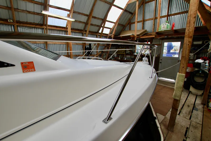 Slide: The Image of 1998 Bayliner 3788 Command Bridge Motoryacht in a wooden boathouse, side view. - 9
