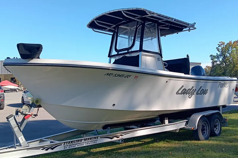 Slide: The Image of 2016 Parker 2300 Special Edition boat on trailer, named "Lady Lou," in outdoor setting. - 6