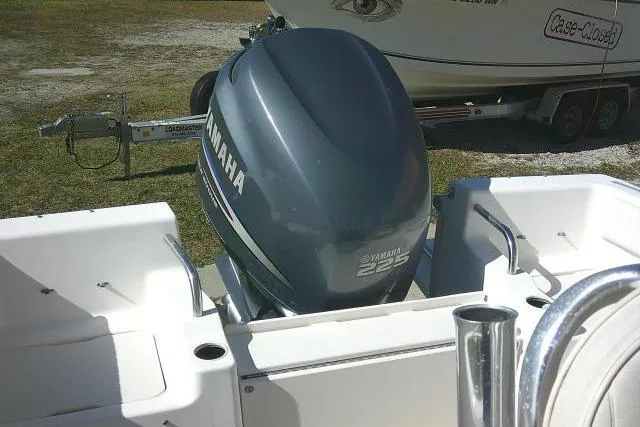 Slide: The Image of 2004 Grady-White Fisherman 209 with Yamaha 225 outboard motor, parked on grass. - 14