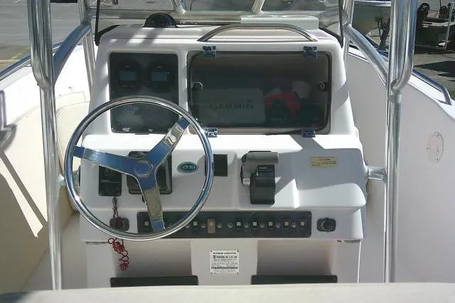 Slide: The Image of 2004 Grady-White Fisherman 209 boat console with steering wheel and Garmin navigation system. - 19