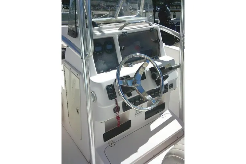 Slide: The Image of 2004 Grady-White Fisherman 209 boat console with steering wheel and controls. - 22