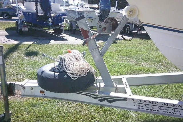 Slide: The Image of Boat trailer with Grady-White Fisherman 209, 2004 model, parked on grass. - 5