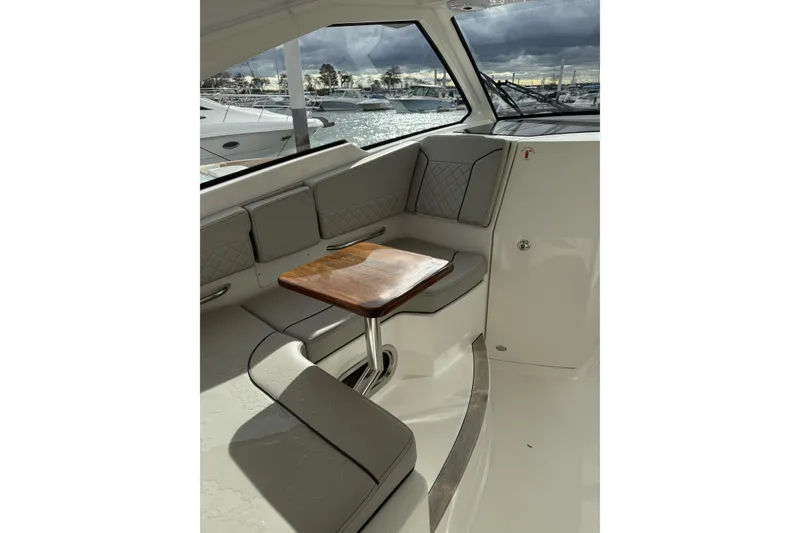 Slide: The Image of Interior of 2022 Pursuit DC 365 Dual Console boat with seating and table. - 12