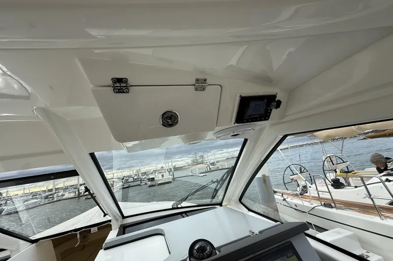 Slide: The Image of Interior view of 2022 Pursuit DC 365 Dual Console boat at a marina. - 19
