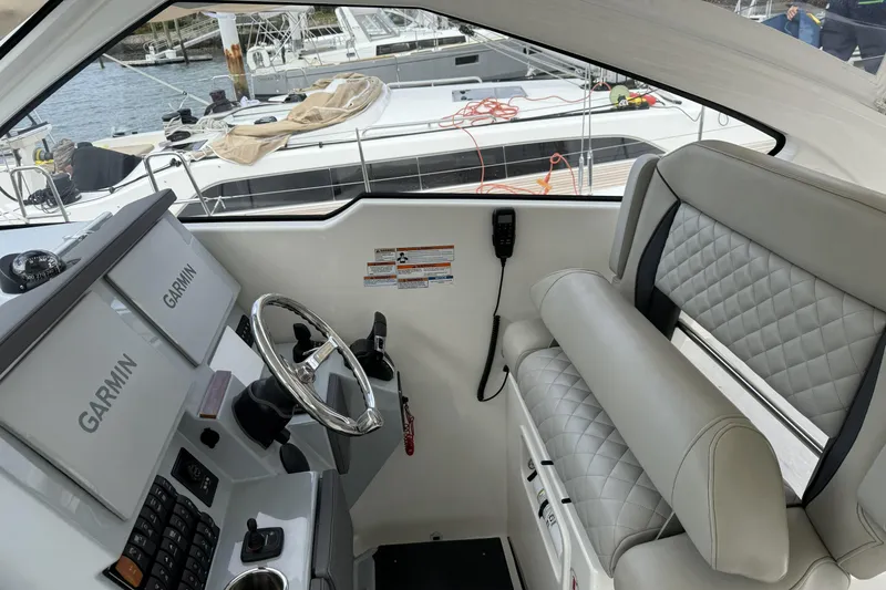 Slide: The Image of 2022 Pursuit DC 365 Dual Console interior with Garmin navigation system and quilted seating. - 24