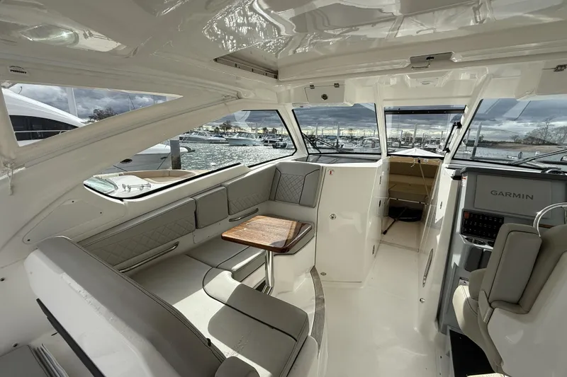 Slide: The Image of Interior of 2022 Pursuit DC 365 Dual Console boat with seating and Garmin navigation. - 28