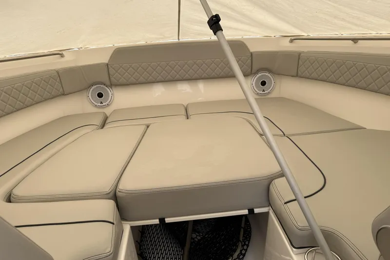 Slide: The Image of 2022 Pursuit DC 365 Dual Console boat interior with beige cushioned seating. - 29
