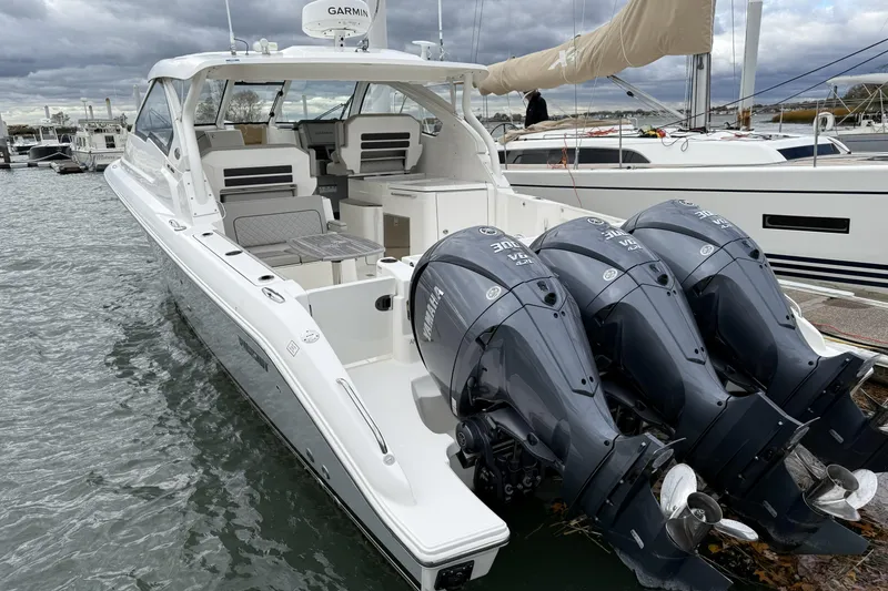Slide: The Image of 2022 Pursuit DC 365 Dual Console boat with triple Yamaha engines docked at marina. - 5