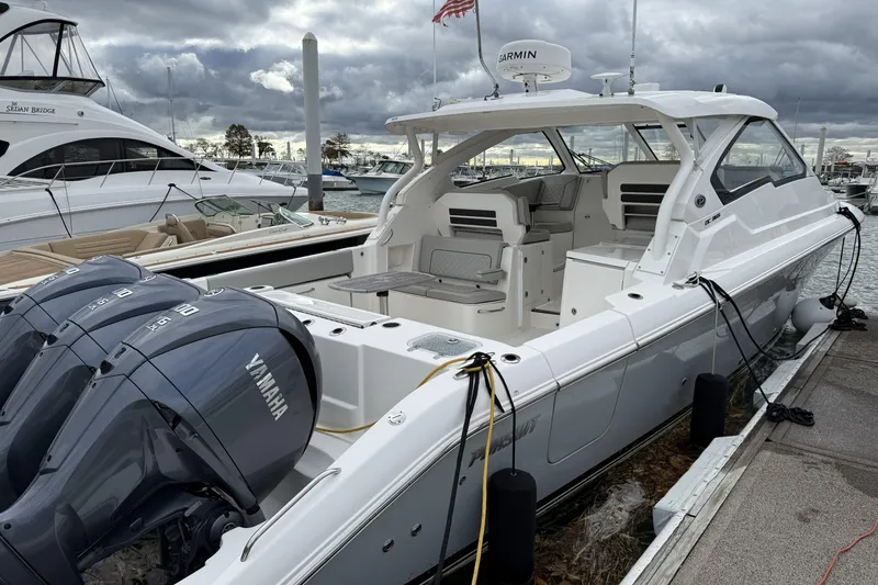 Slide: The Image of 2022 Pursuit DC 365 Dual Console boat docked, featuring Yamaha engines and sleek design. - 6