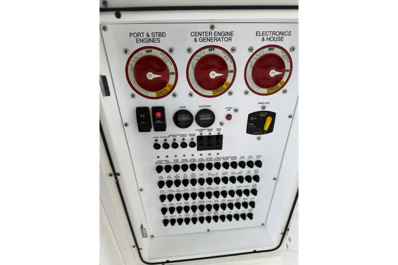 Slide: The Image of Control panel of 2022 Pursuit DC 365 Dual Console boat with engine and electronics switches. - 9
