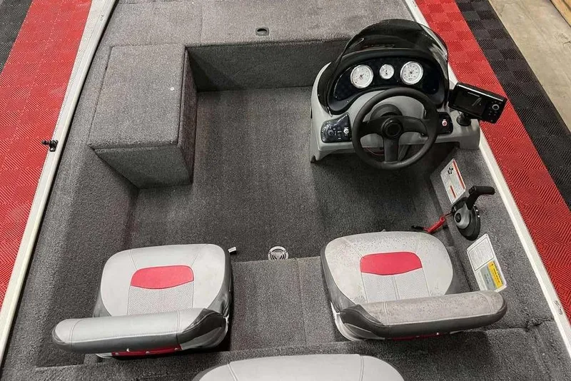 Slide: The Image of 2014 Tracker Pro 170 boat interior with steering console and two seats. - 3