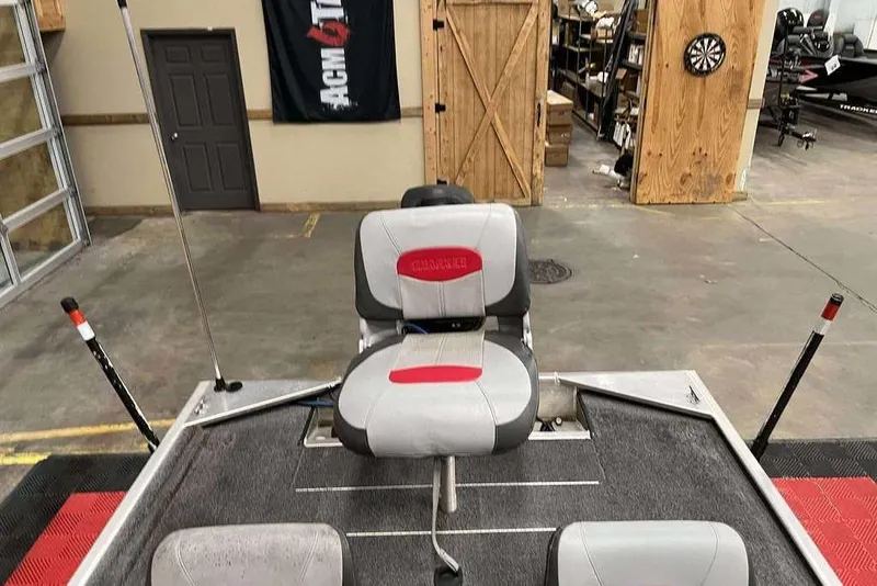 Slide: The Image of 2014 Tracker Pro 170 boat interior with seating in a garage setting. - 4