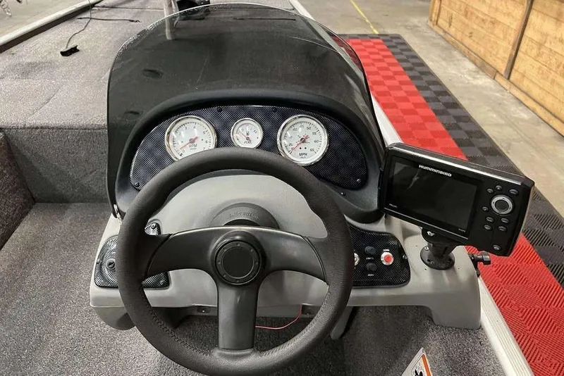 Slide: The Image of 2014 Tracker Pro 170 boat dashboard with steering wheel and electronic display. - 5