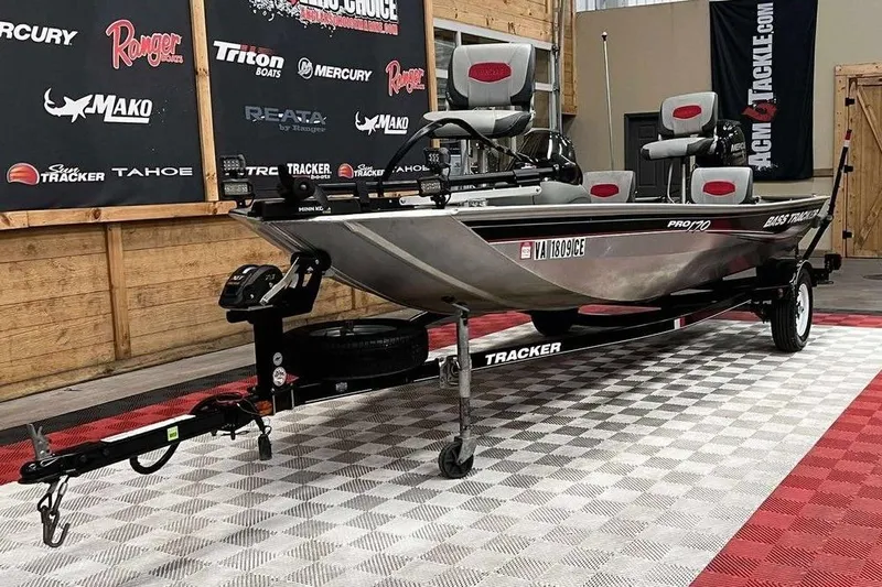 Slide: The Image of 2014 Tracker Pro 170 boat on display in showroom with promotional banners. - 7