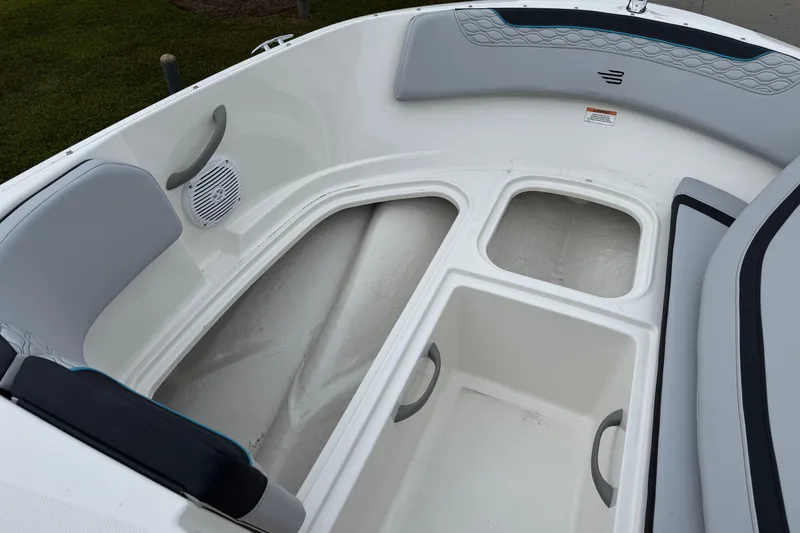 Slide: The Image of Interior view of 2026 Bayliner M19 boat, featuring storage compartments and seating. - 11