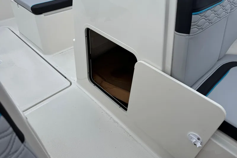Slide: The Image of 2026 Bayliner M19 boat interior storage compartment with open door. - 13