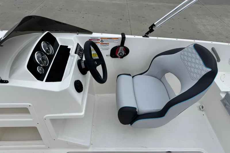 Slide: The Image of 2026 Bayliner M19 boat cockpit with steering wheel and cushioned seat. - 14
