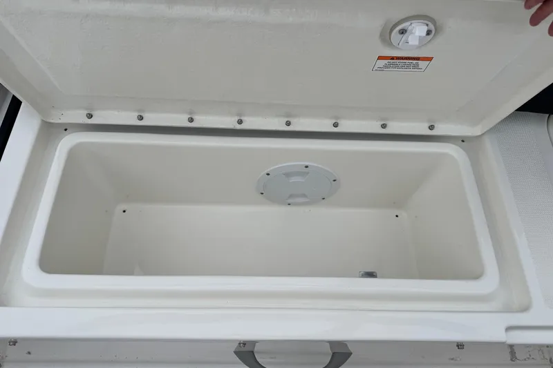 Slide: The Image of Open storage compartment on 2026 Bayliner M19 boat, showcasing interior space. - 18