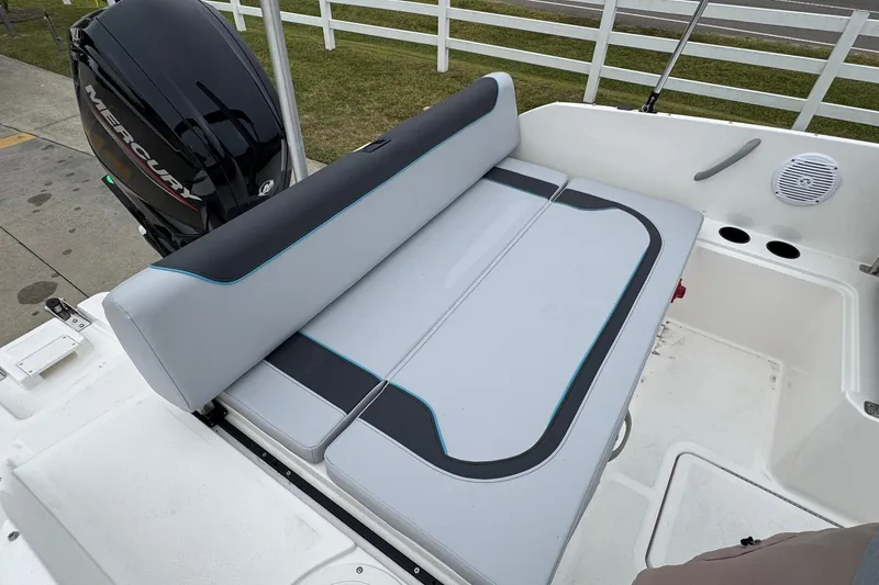 Slide: The Image of 2026 Bayliner M19 boat interior with cushioned seating and Mercury outboard motor. - 6