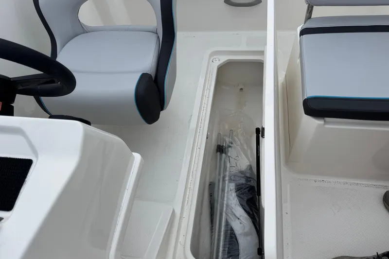Slide: The Image of Interior of 2026 Bayliner M19 boat showing seating and storage compartment. - 15