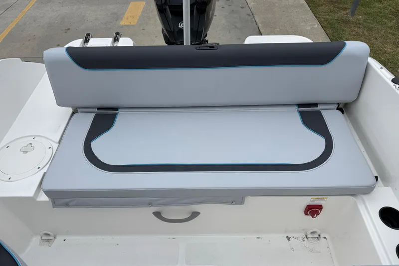 Slide: The Image of 2026 Bayliner M19 boat seat with gray and black upholstery, featuring blue accents. - 17