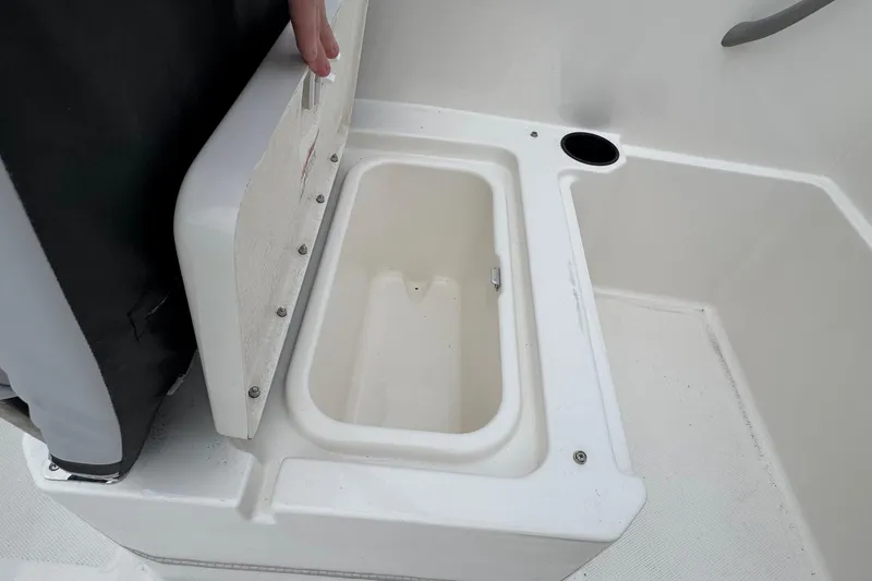 Slide: The Image of Bayliner M19 2026 boat storage compartment with open lid, showcasing interior space. - 7