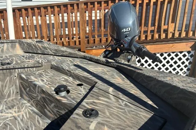 Slide: The Image of 2025 G3 1652 CC boat on LoadRite trailer, parked outdoors. - 2