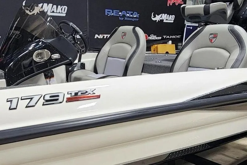 Slide: The Image of 2026 Triton 179 TrX boat interior with branded seating and console. - 12