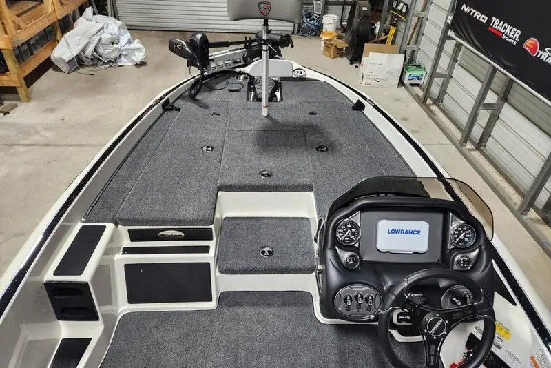 Slide: The Image of 2026 Triton 179 TrX boat interior with Lowrance navigation system and spacious deck. - 5