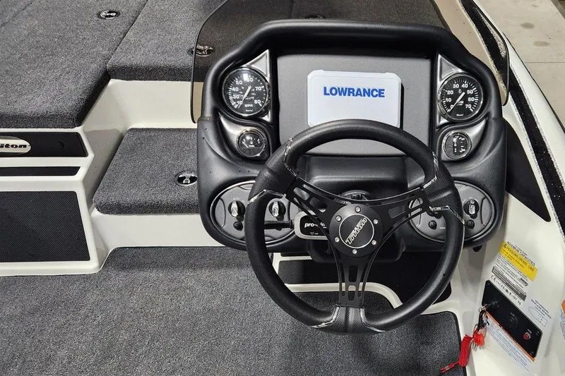 Slide: The Image of 2026 Triton 179 TrX boat dashboard with Lowrance display and steering wheel. - 9