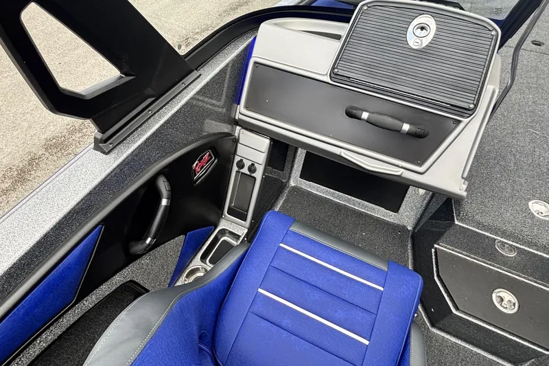 Slide: The Image of Interior of 2026 Ranger 1880MS A Pack Equipped boat with blue seating and storage compartments. - 10