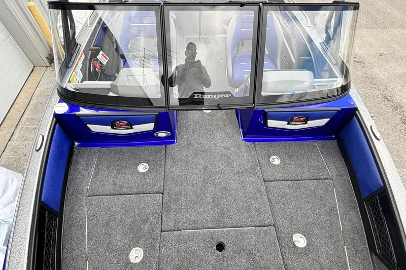 Slide: The Image of 2026 Ranger 1880MS A Pack Equipped boat interior with blue accents and seating. - 7