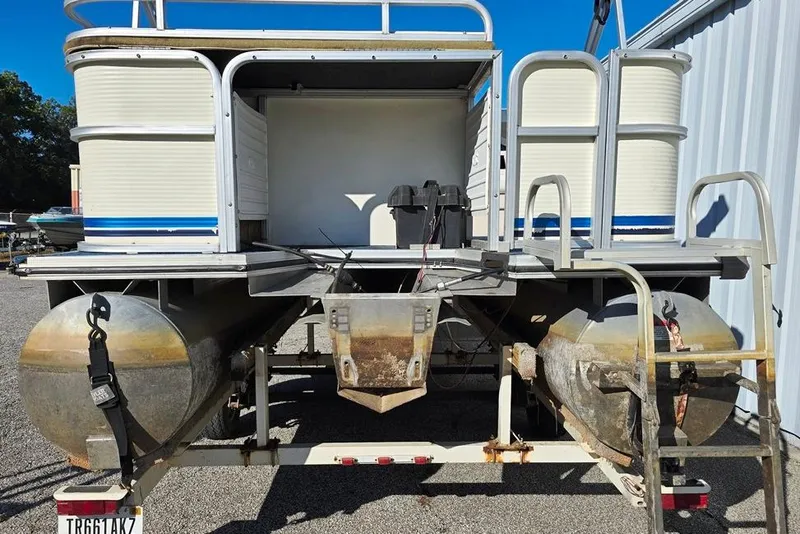 Slide: The Image of 1999 Lowe Trinidad 220 pontoon boat rear view, parked on a trailer. - 8