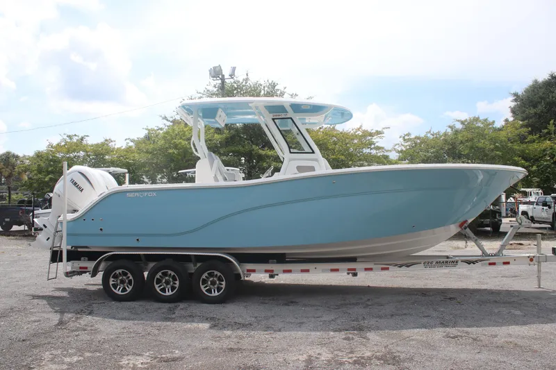 The Image of 2026 Sea Fox 288 Commander boat on trailer, parked outdoors. - 1
