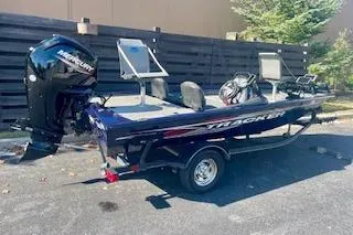 Slide: The Image of 2022 Tracker Pro Team 175 TF boat with Mercury engine, parked outdoors. - 10
