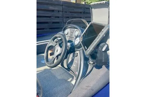 Slide: The Image of 2022 Tracker Pro Team 175 TF boat dashboard with steering wheel and control panel. - 3