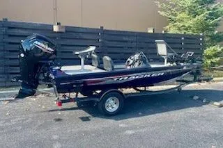 Slide: The Image of 2022 Tracker Pro Team 175 TF boat parked outdoors on a trailer. - 4