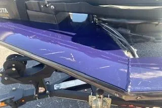 Slide: The Image of 2022 Tracker Pro Team 175 TF boat with visible scratches on the purple hull. - 9
