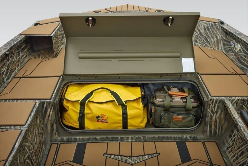 Slide: The Image of 2026 Tracker Grizzly 1756 T Marsh boat storage with yellow and green bags. - 13