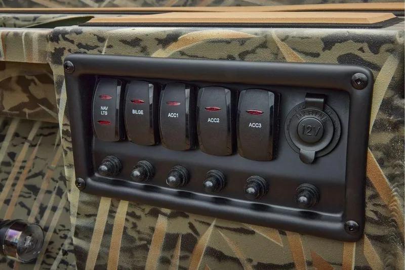 Slide: The Image of Control panel of 2026 Tracker Grizzly 1756 T Marsh boat with camo design. - 3